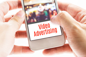 Close up Two hand holding mobile with Video Advertising word, Digital business concept.
